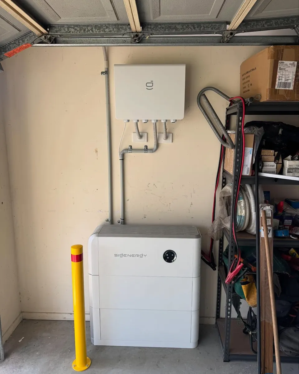 A battery in a garage, protected by a bollard, a Green Coast job